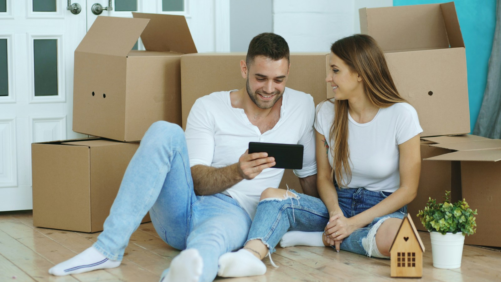 Couple planning their move among moving boxes